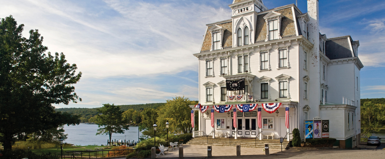 Historic Goodspeed Opera House with river and trees in East Haddam