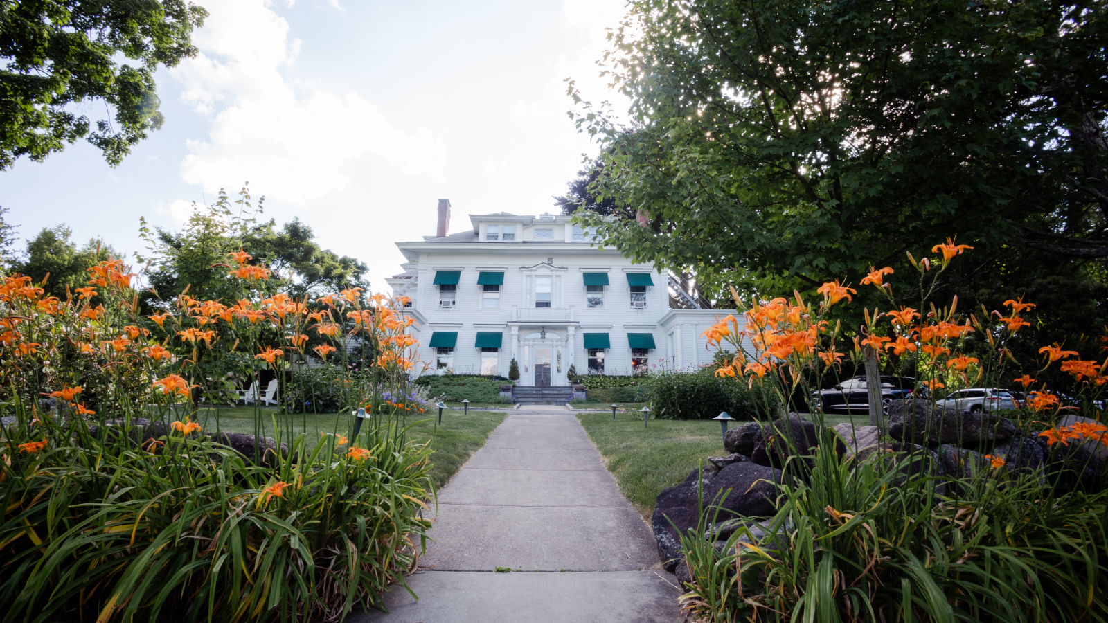 The front of Stanton House Inn, in front of tiger lilies