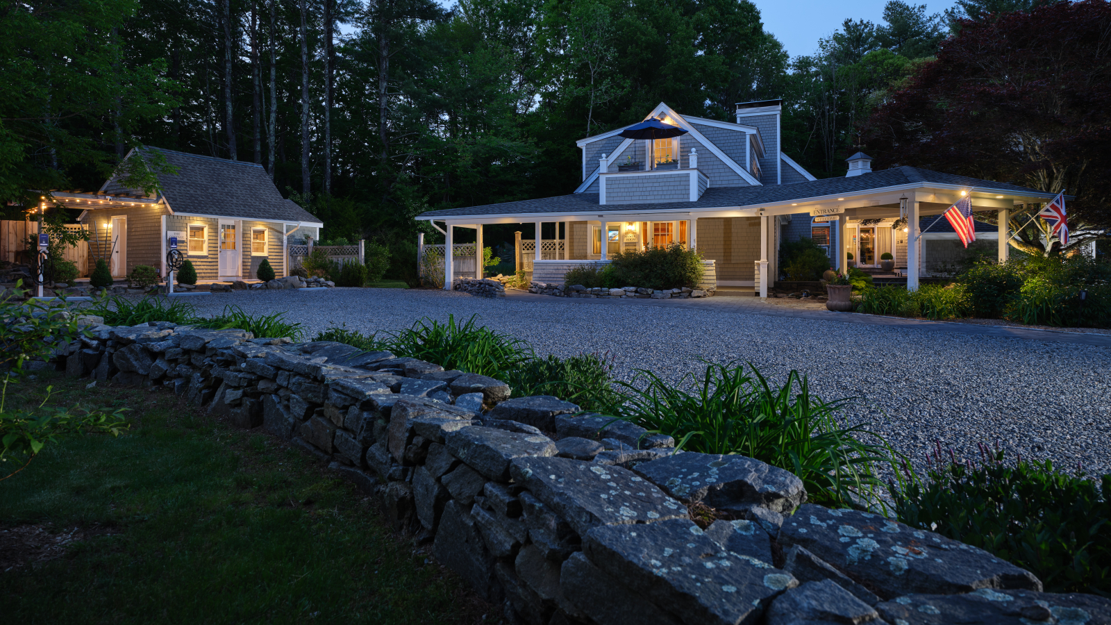 The main house and cottage at Abbey's Lantern Hill Inn illuminated at dusk