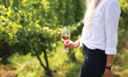 Woman holding glass of wine at Saltwater Vineyards 