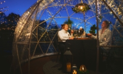 Outdoor dining in see-through igloo