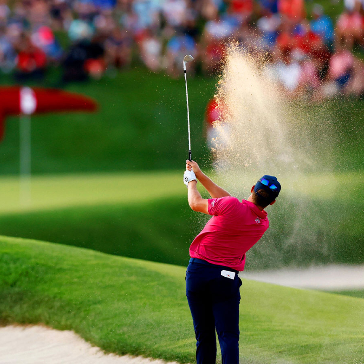 Professional golfer hitting shot out of bunker at the Travelers Championship