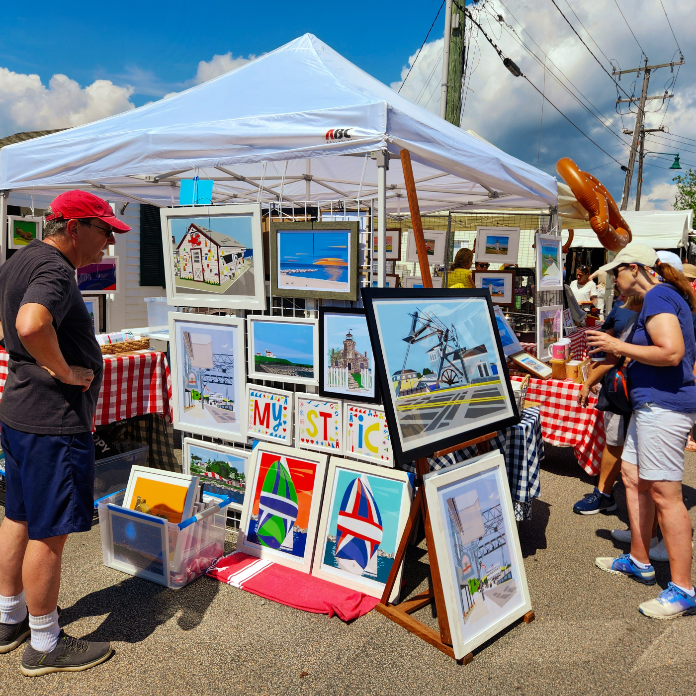 Shoppers peruse the offerings at the Mystic Art Festival 