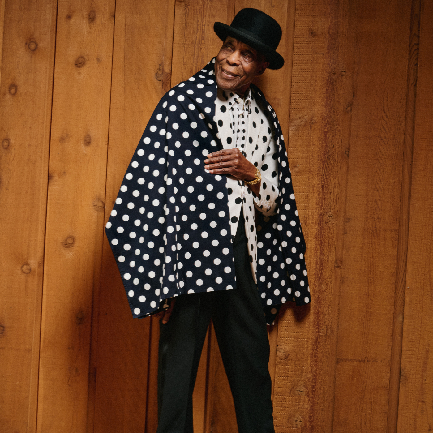 Man in bowler hat and polka dot jacket