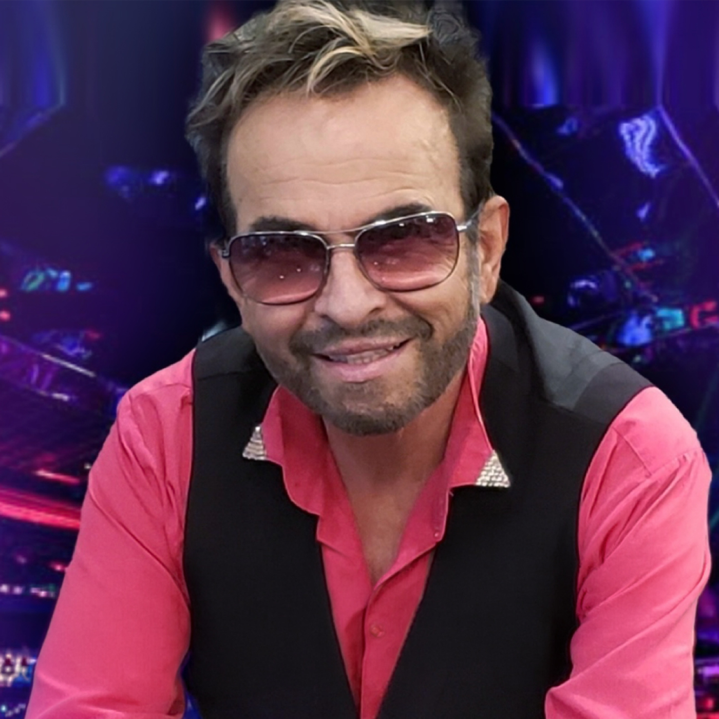 Man in pink shirt black vest