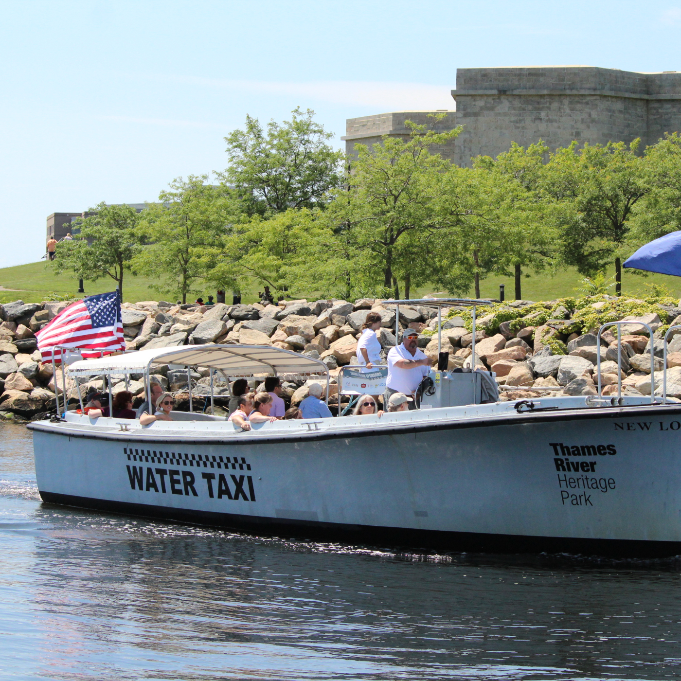 Hop On, Hop Off Harbor Cruise in the river with Fort Trumbull in the background.