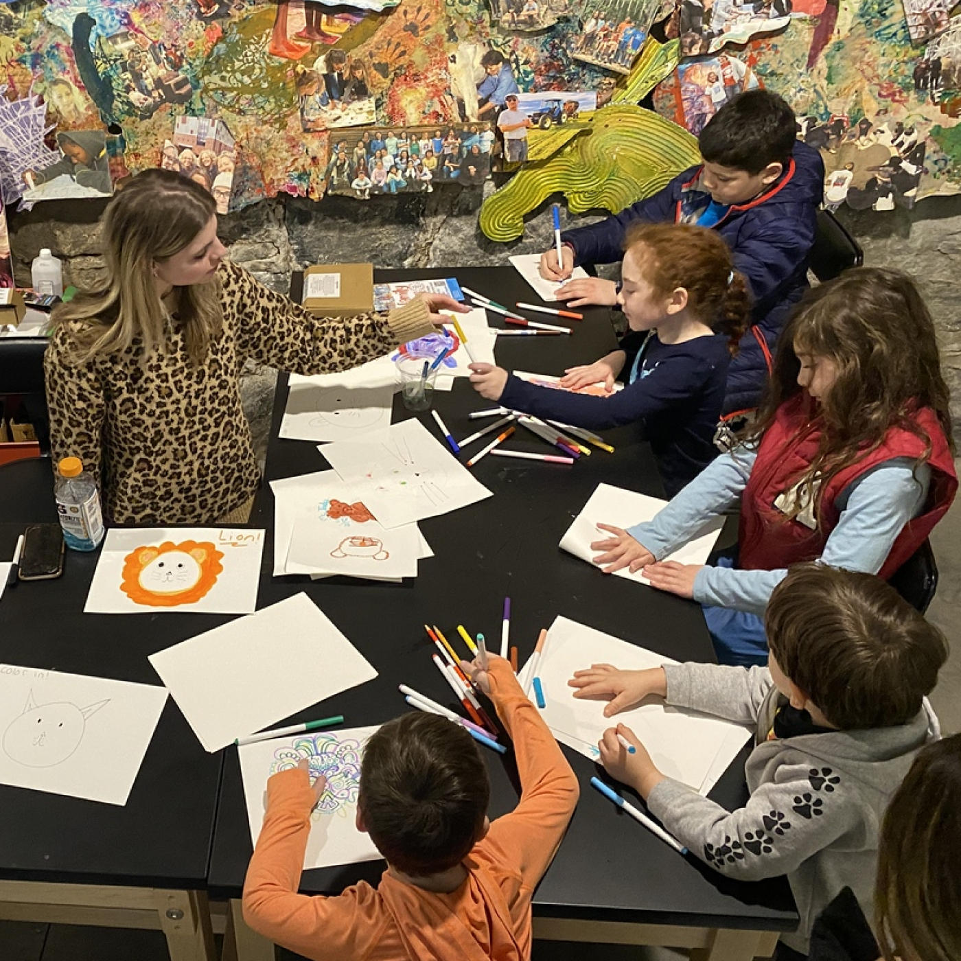 Art educator from the american mural project running an art activity from a previous family day.