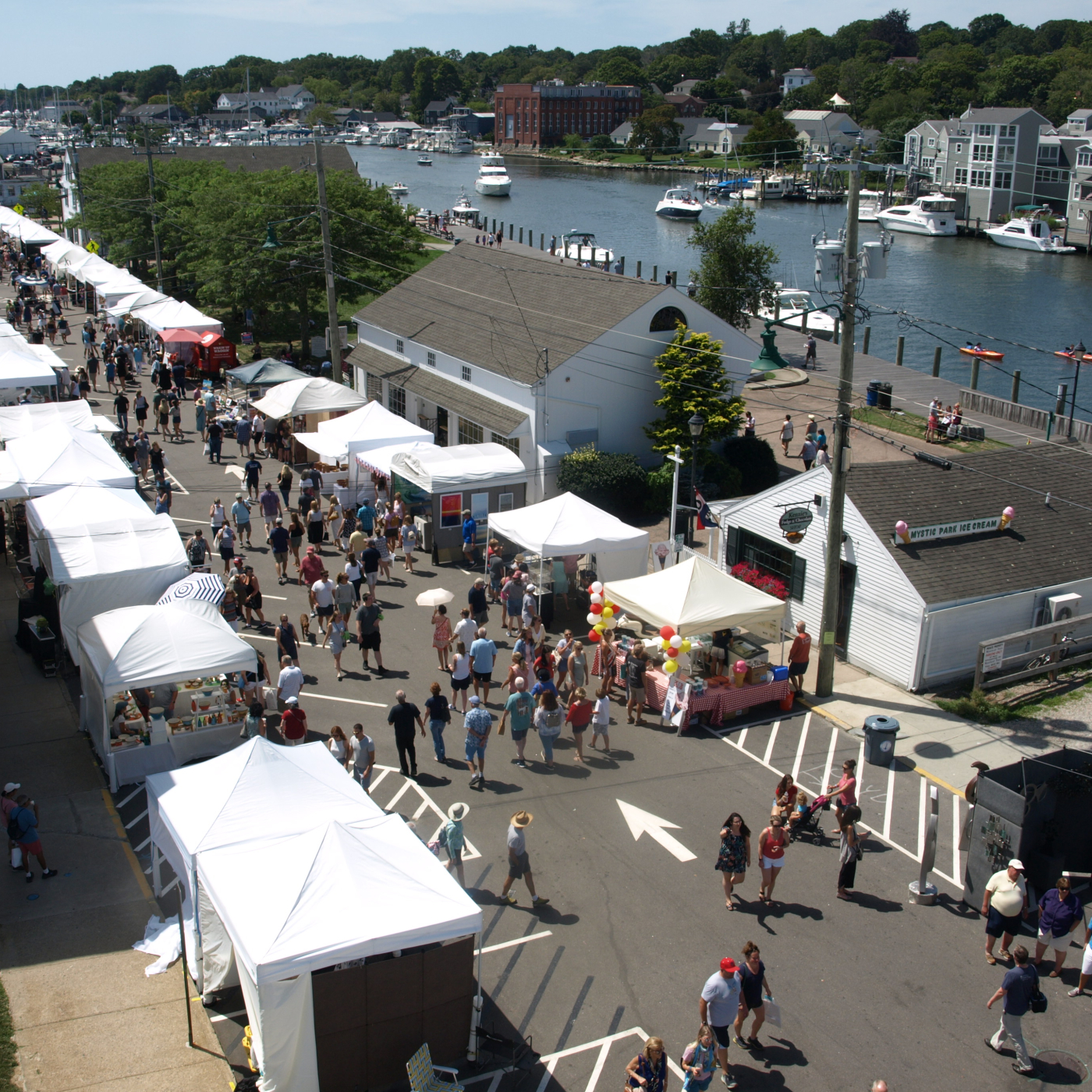 Guests enjoy the Mystic Outdoor Art Festival that stretches along the Mystic River