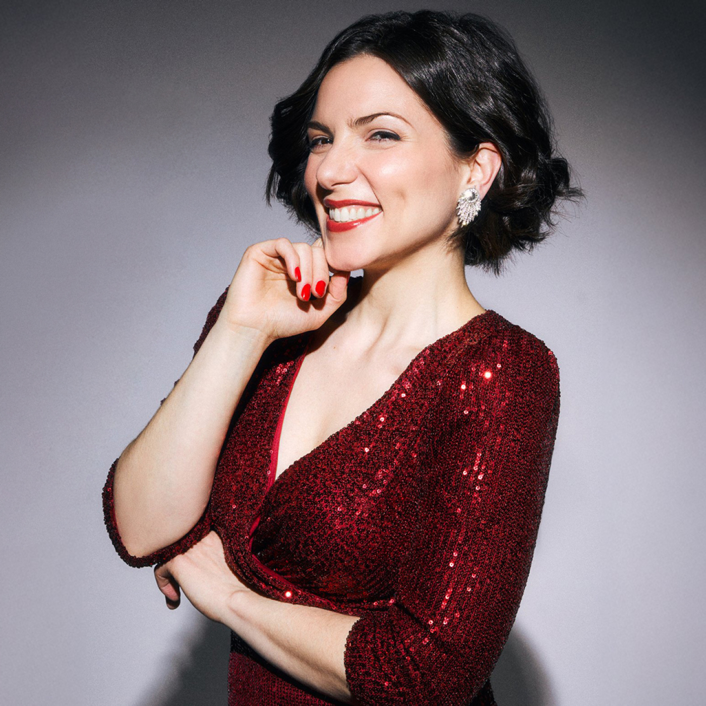 Woman smiling in a red sparkly dress 