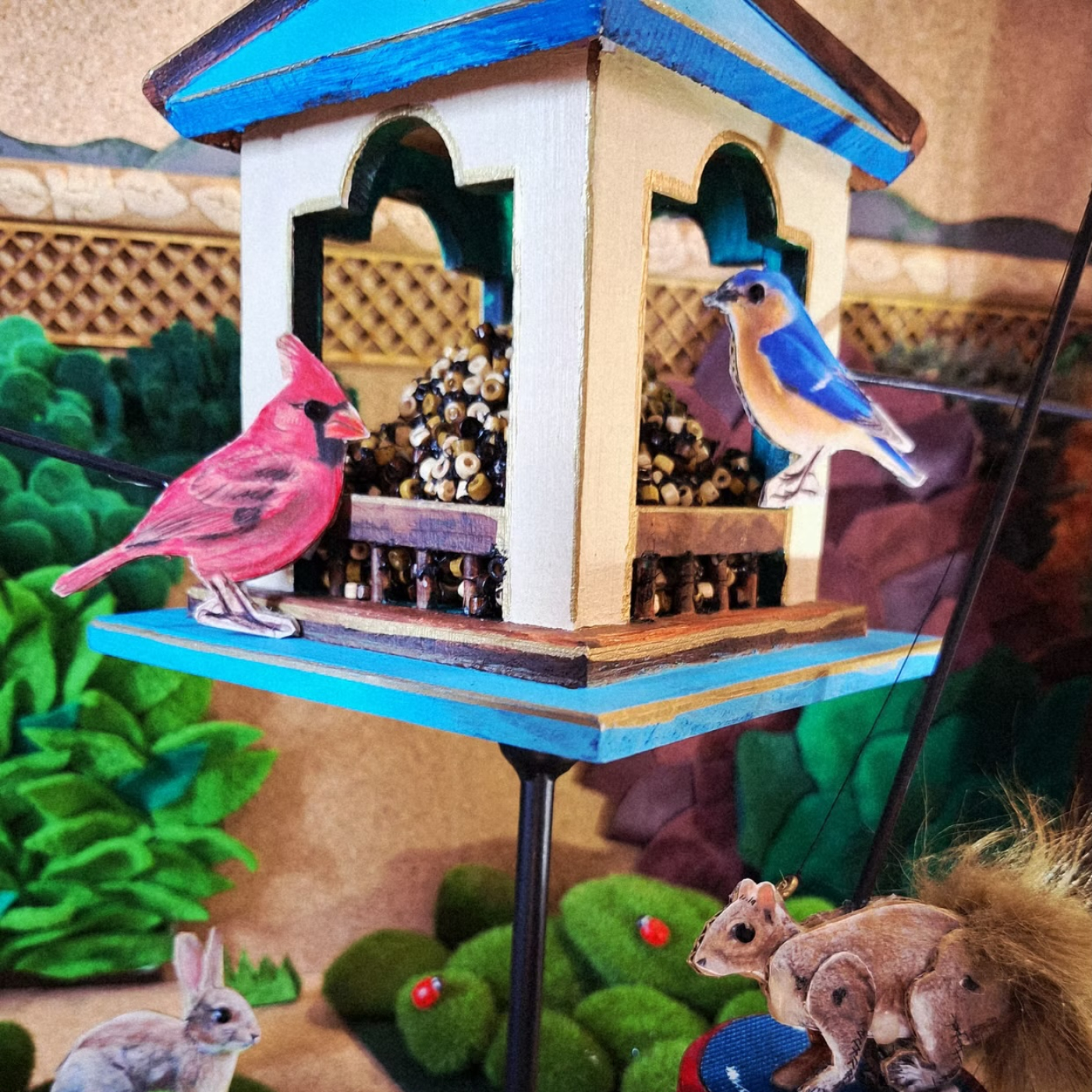 Scene of Birds and Squirrels in a Birdhouse 