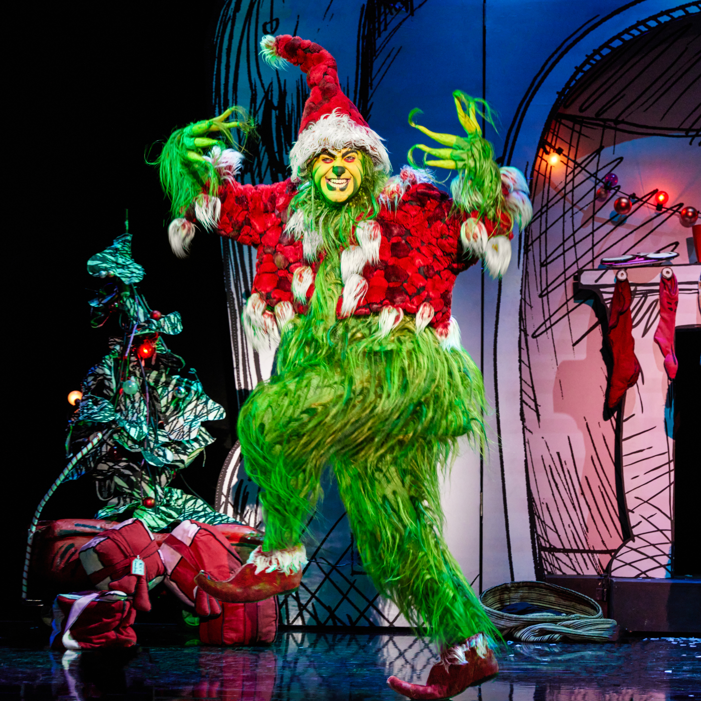 The Grinch wearing Santa clothes with a menacing look on his face.