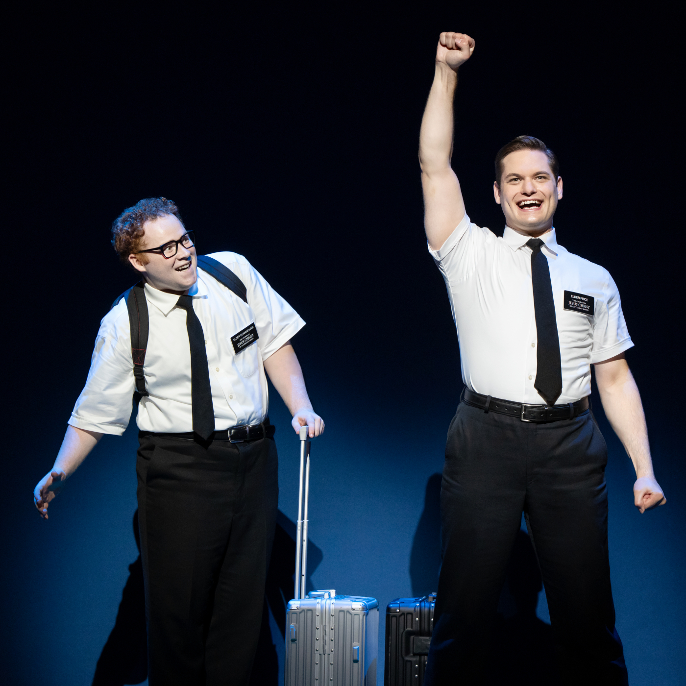 Two white men wearing missionary outfit looking excited.