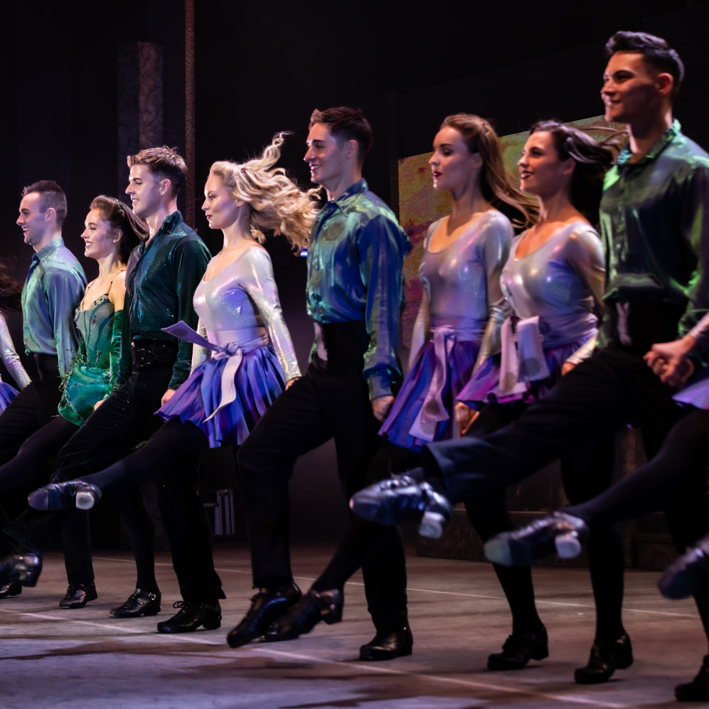 Line of Irish step dancers on stage.