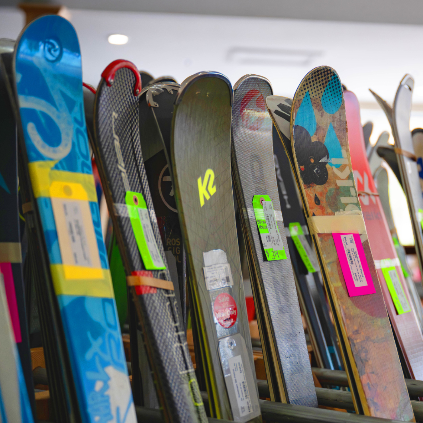 Ski racks holding a variety of used and new skis