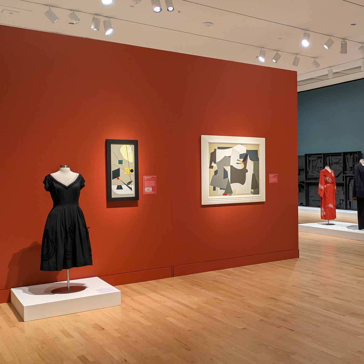 Gallery Exhibition with paintings, drawings, and clothing