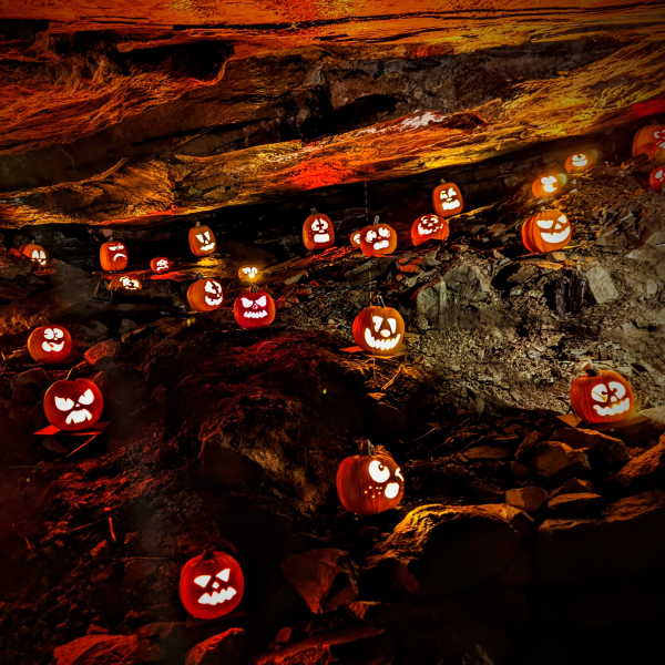 20 lit Jack O' Lanterns displayed in the underground caverns of the copper mine at Old New-Gate.