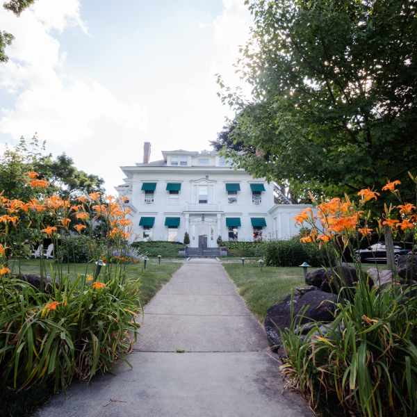 The front of Stanton House Inn, in front of tiger lilies