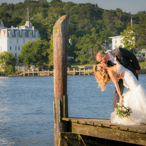 A couple shares an intimate moment near the CT River on their wedding day