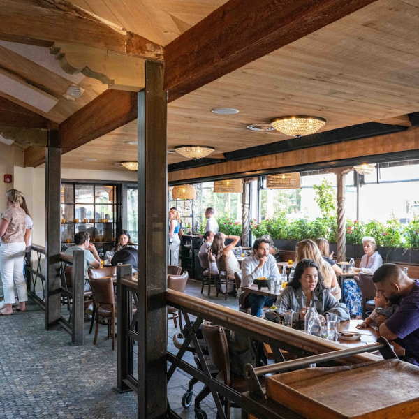 Guests sit and stand in the interior of Geronimo restaurant in Fairfield CT