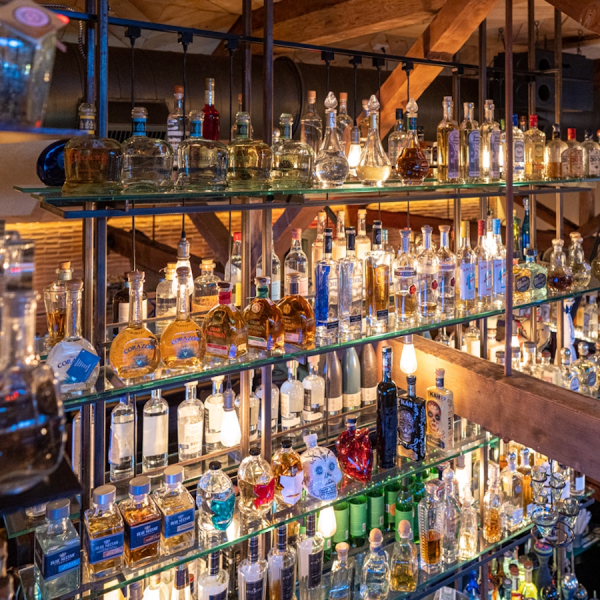 A photo of liquor bottles on shelves at Geronimo restaurant in Fairfield CT