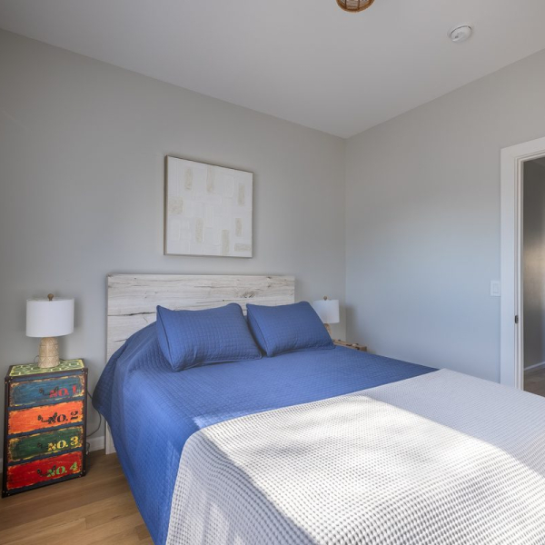 Second queen guest room with playful coastal details, spacious closet and bedside charging stations.