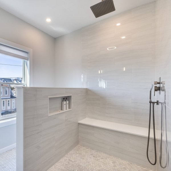 Spa-inspired primary bathroom with oversized walk-in shower, double vanity, and built-in Bluetooth speakers 