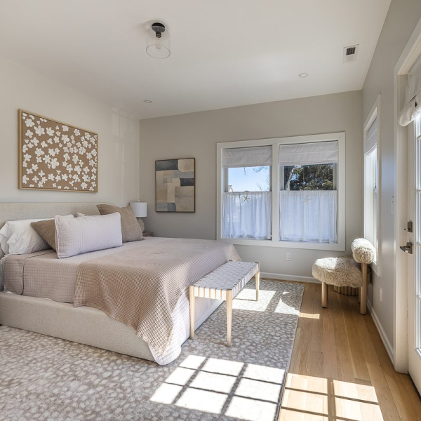 Light-filled king suite with private Trex balcony and spa-inspired bath at Walnut Beach Luxury House.