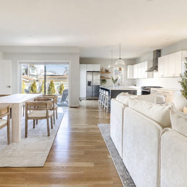 Sunlit open-plan living and dining area with 9-foot ceilings, wide-plank hardwood floors and a chef’s kitchen 