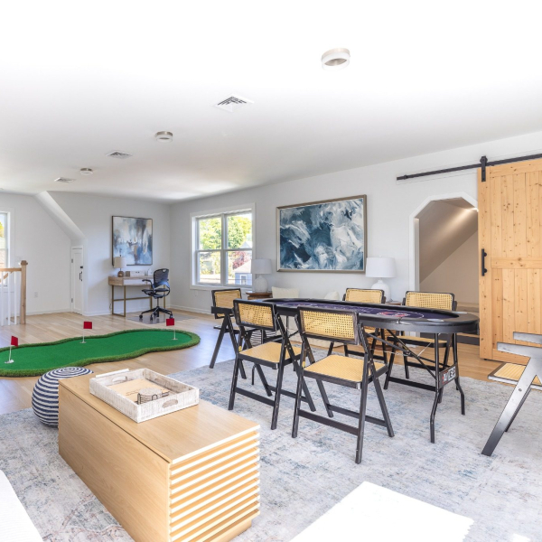 Third-floor game lounge with putting green, card table, lounge seating and second workspace