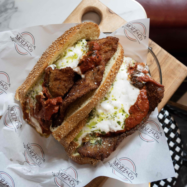 A sandwich from Mozz & Co. with fried chicken cutlets, cheese and sauce
