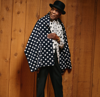 Man in bowler hat and polka dot jacket