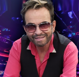 Man in pink shirt black vest