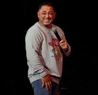 Man smiling holding microphone