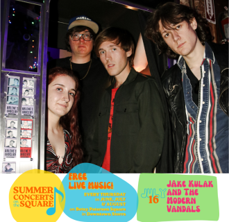 Four young people gather in and around a photo booth