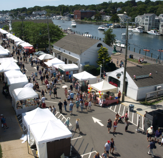 Guests enjoy the Mystic Outdoor Art Festival that stretches along the Mystic River