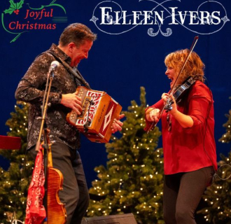 Eileen Ivers and her performance partner, Eileen is playing a violin and her partner is playing an accordion
