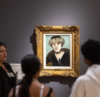 People in a museum looking at a portrait 