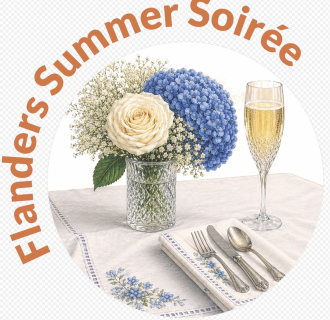 The image contains a vase with flowers, a champagne flute, and a fork, knife and spoon laying on top of a table.