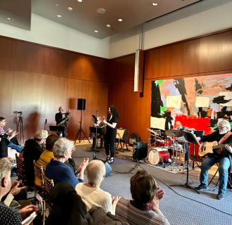 Patrons seated in front of live band 