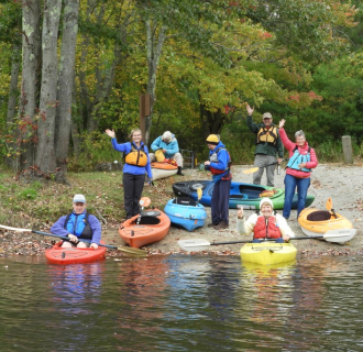 Group of kayakers waving