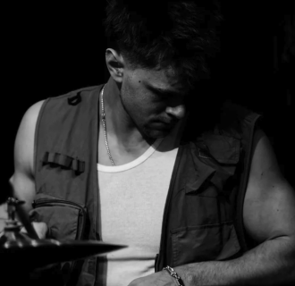 Black and white image of a male percussionist.