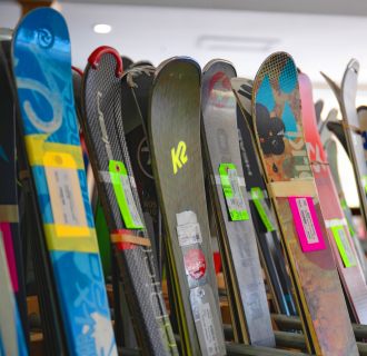 Ski racks holding a variety of used and new skis