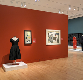 Gallery Exhibition with paintings, drawings, and clothing