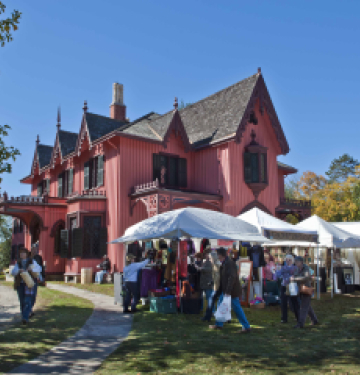 Roseland Cottage with market tents and people at outdoor fair