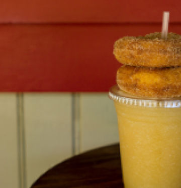 Cider slushie with two cinnamon sugar donuts on top