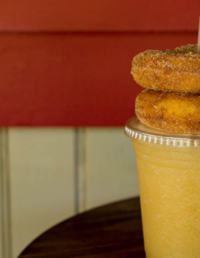 Cider slushie with two cinnamon sugar donuts on top