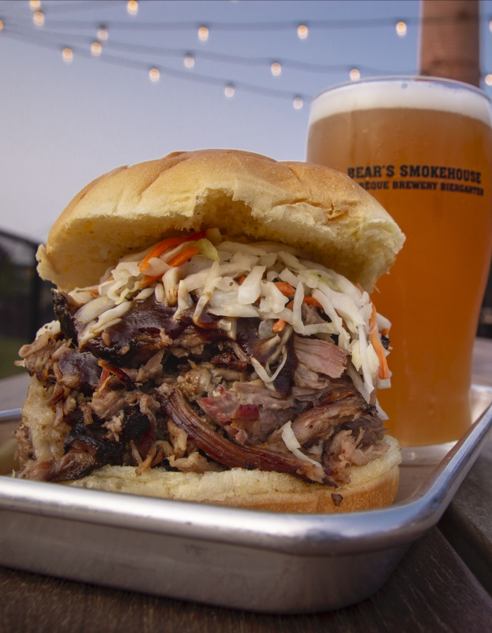 Barbecue pulled pork sandwich with coleslaw and beer at outdoor patio