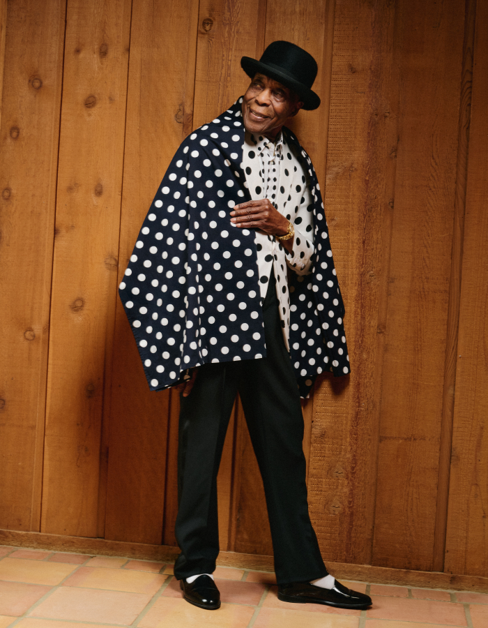 Man in bowler hat and polka dot jacket