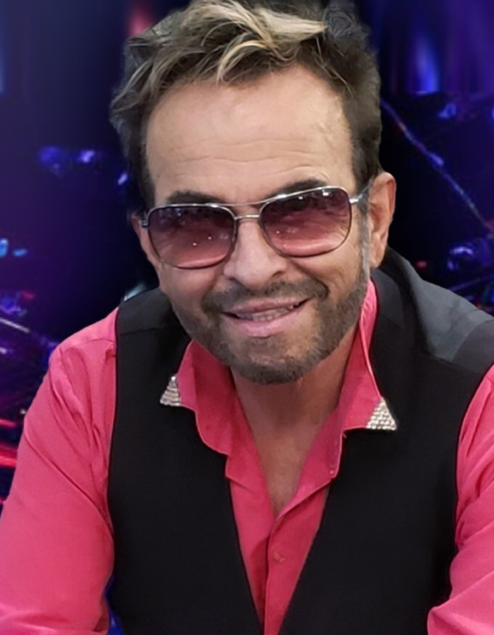 Man in pink shirt black vest