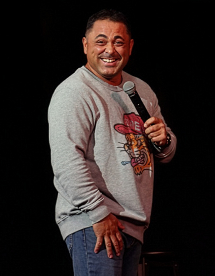 Man smiling holding microphone